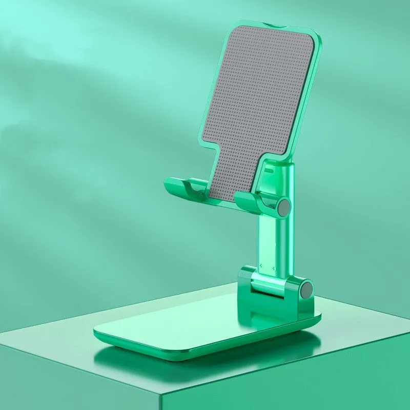Folding telescopic mobile phone bracket in white, blue, green, or pink colours on a desktop.