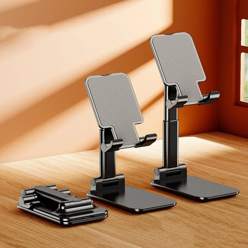 Folding telescopic mobile phone bracket in white, blue, green, or pink colours on a desktop.