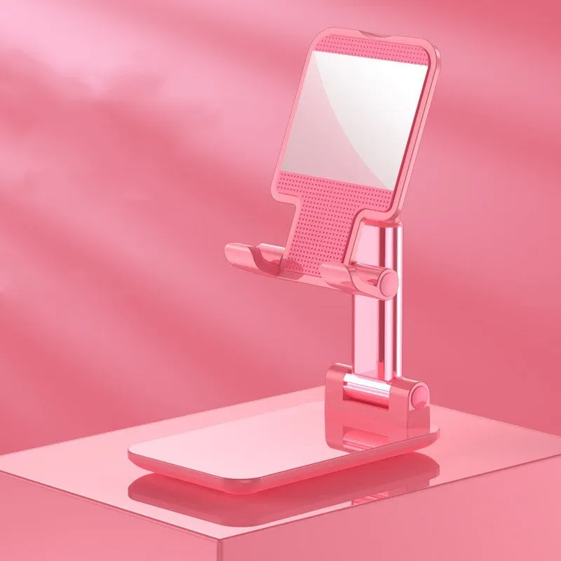 Folding telescopic mobile phone bracket in white, blue, green, or pink colours on a desktop.
