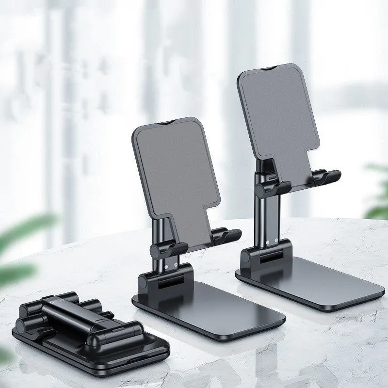 Folding telescopic mobile phone bracket in white, blue, green, or pink colours on a desktop.