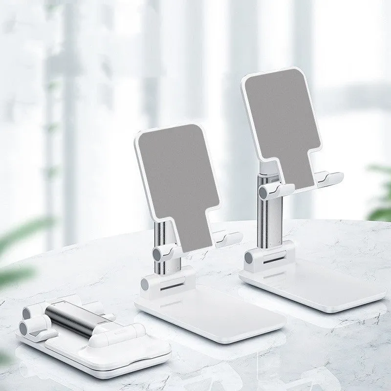 Folding telescopic mobile phone bracket in white, blue, green, or pink colours on a desktop.