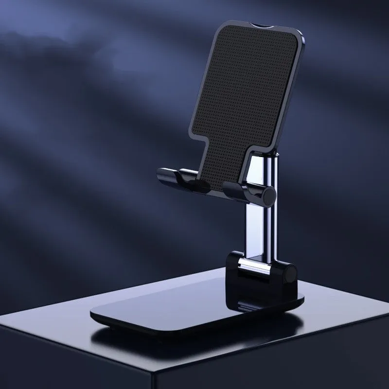 Folding telescopic mobile phone bracket in white, blue, green, or pink colours on a desktop.