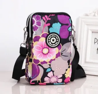 Vertical Oxford fabric ladies mobile phone bag with a zipper, shown in a printed design.