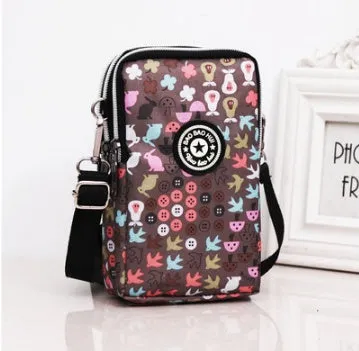 Vertical Oxford fabric ladies mobile phone bag with a zipper, shown in a printed design.