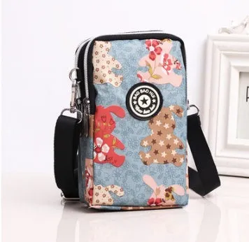 Vertical Oxford fabric ladies mobile phone bag with a zipper, shown in a printed design.