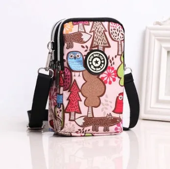 Vertical Oxford fabric ladies mobile phone bag with a zipper, shown in a printed design.