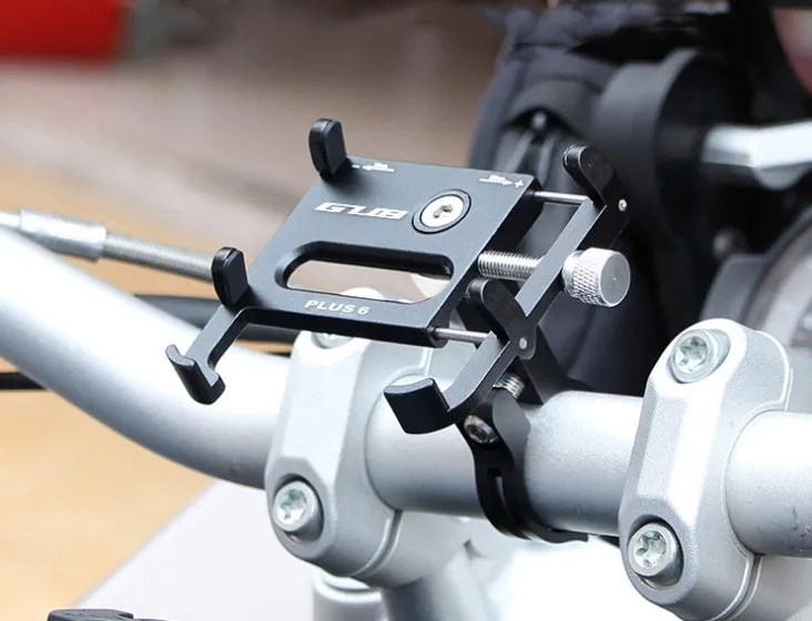 Black aluminium motorcycle phone holder mounted on handlebars, showing adjustable clamp and rotating joint.