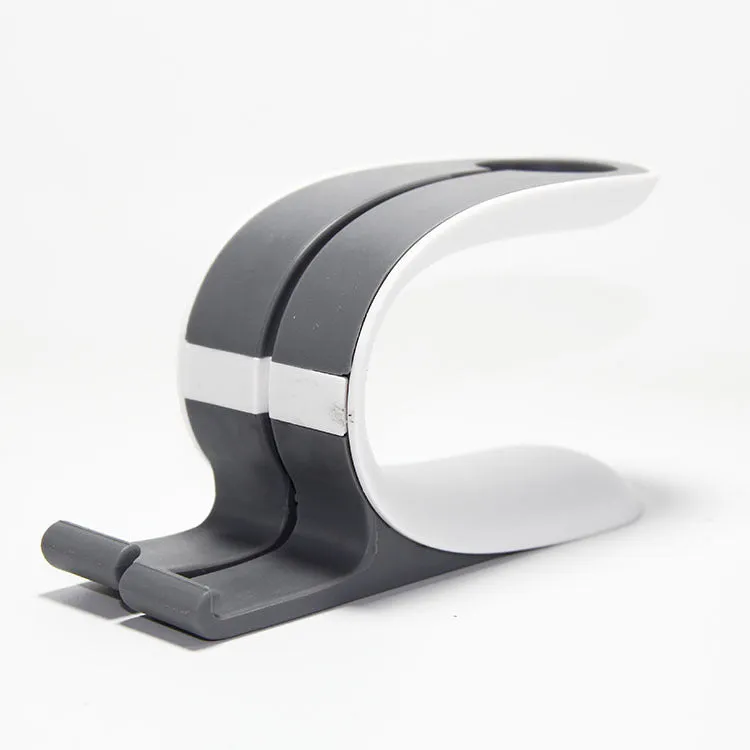 Grey and green Apple iPhone and Apple Watch charging stand on desktop
