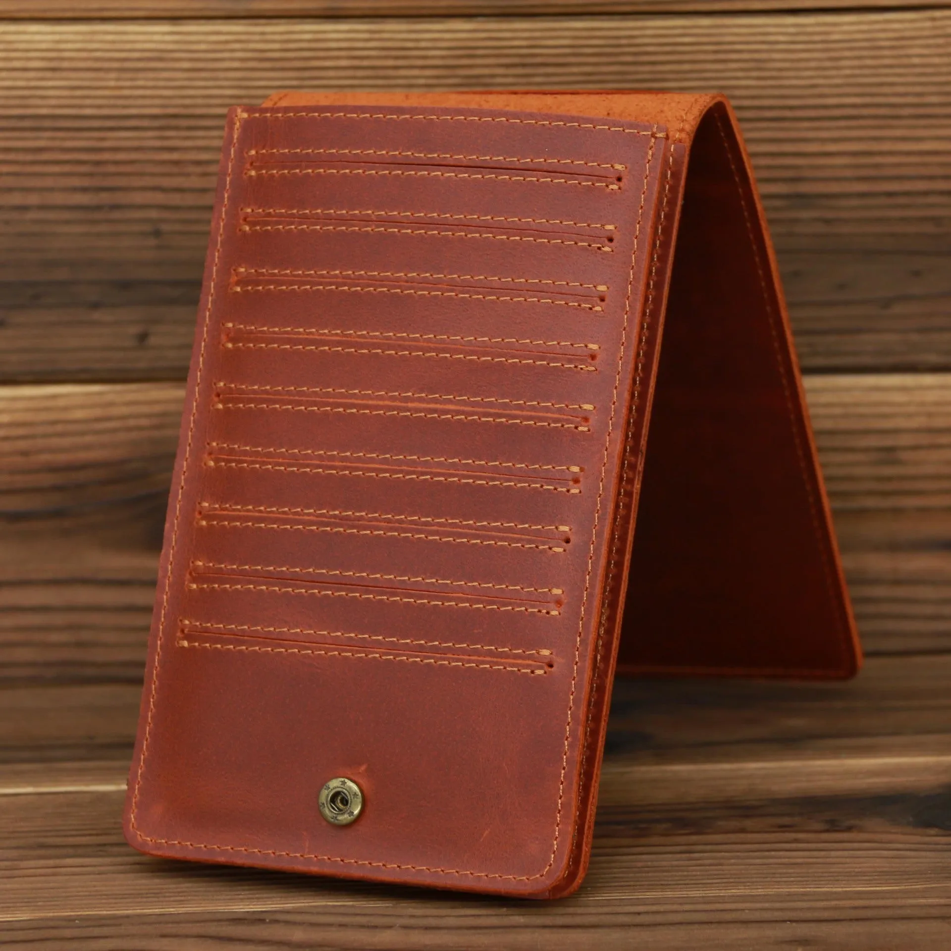 Men's long cowhide leather wallet showing card slots, money pocket, and mobile phone compartment.