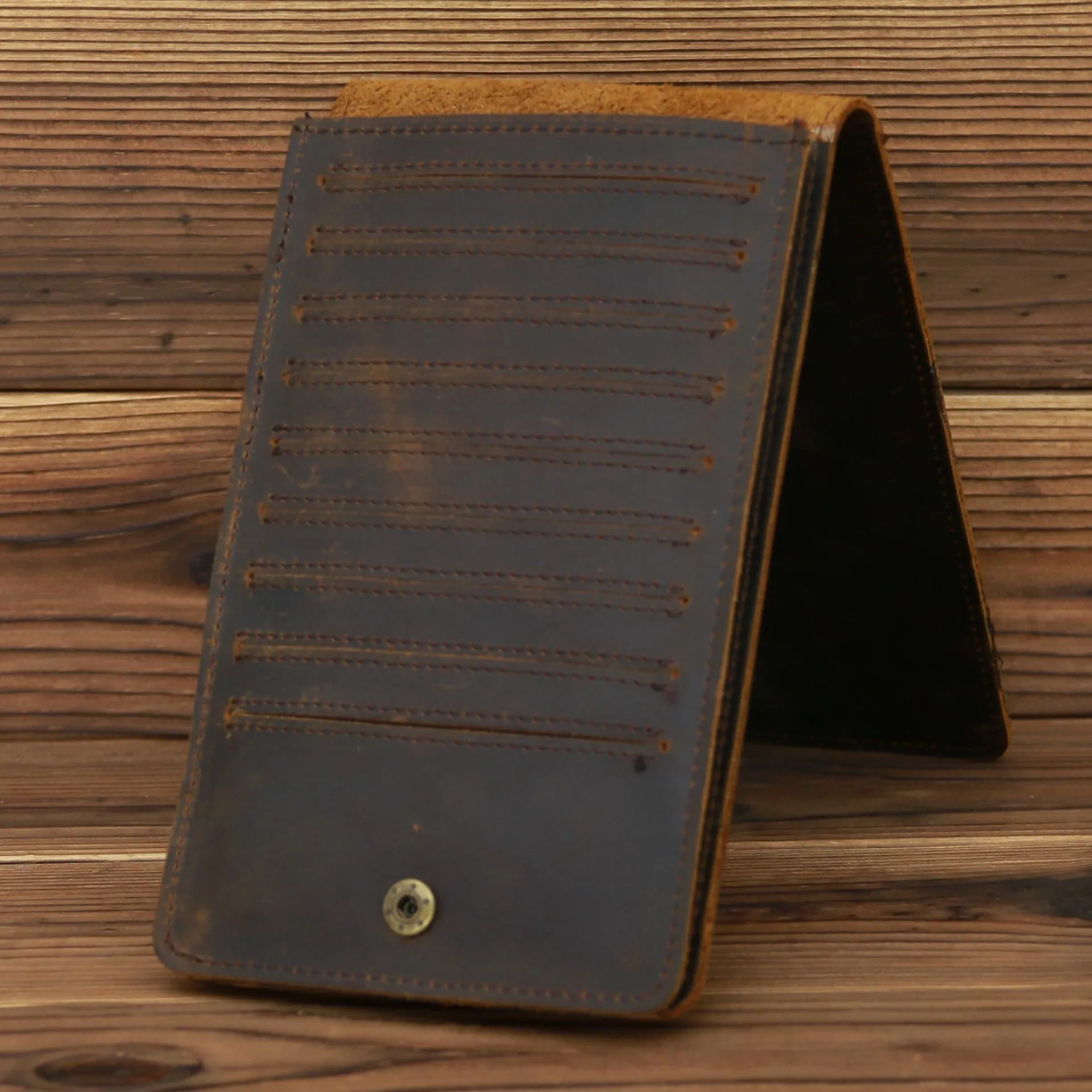 Men's long cowhide leather wallet showing card slots, money pocket, and mobile phone compartment.