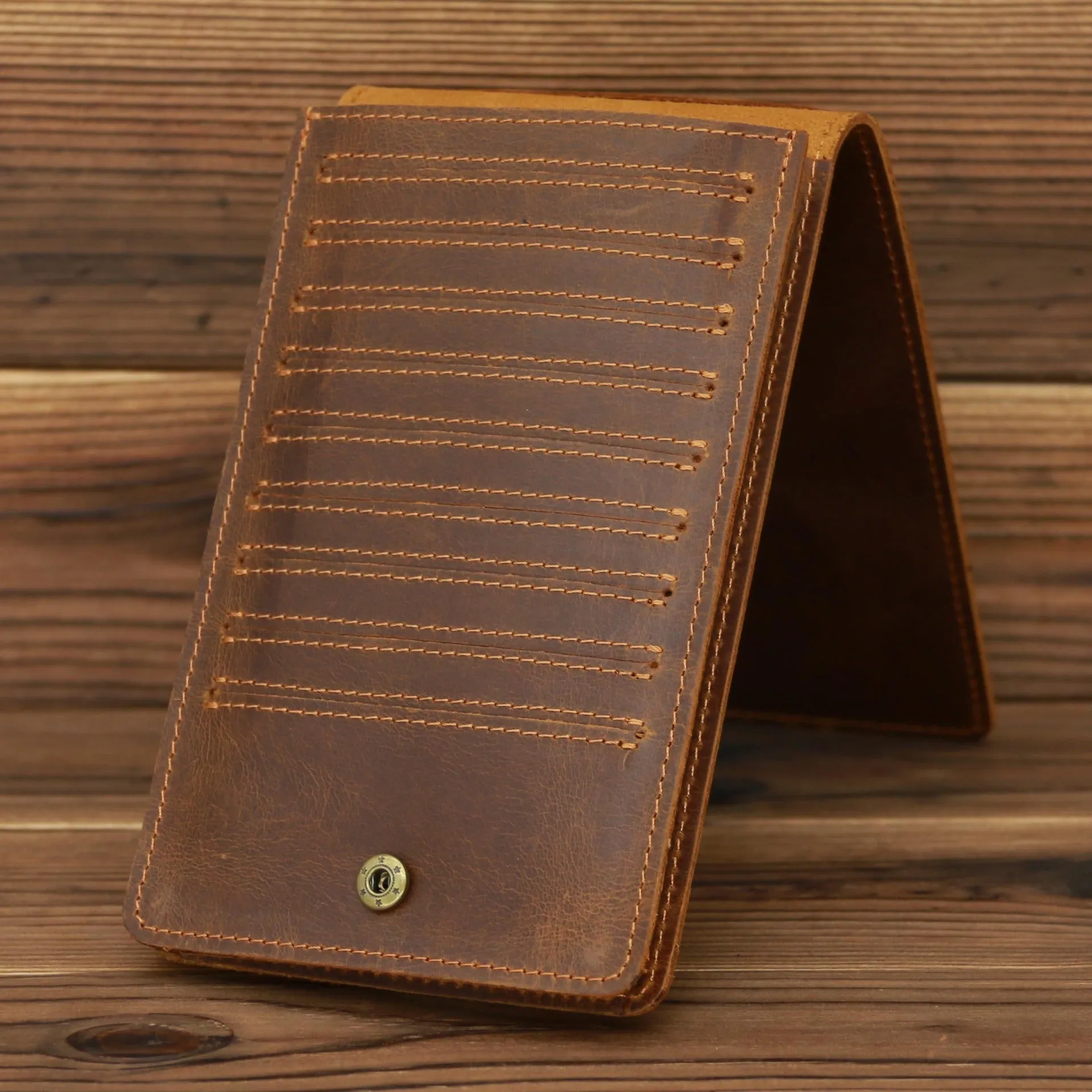 Men's long cowhide leather wallet showing card slots, money pocket, and mobile phone compartment.
