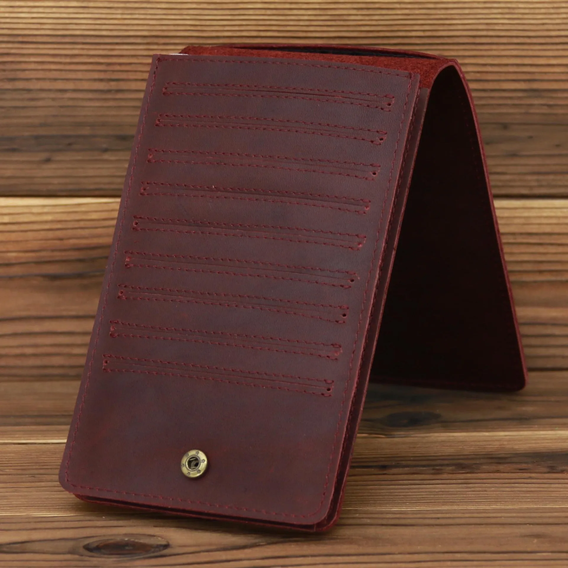 Men's long cowhide leather wallet showing card slots, money pocket, and mobile phone compartment.