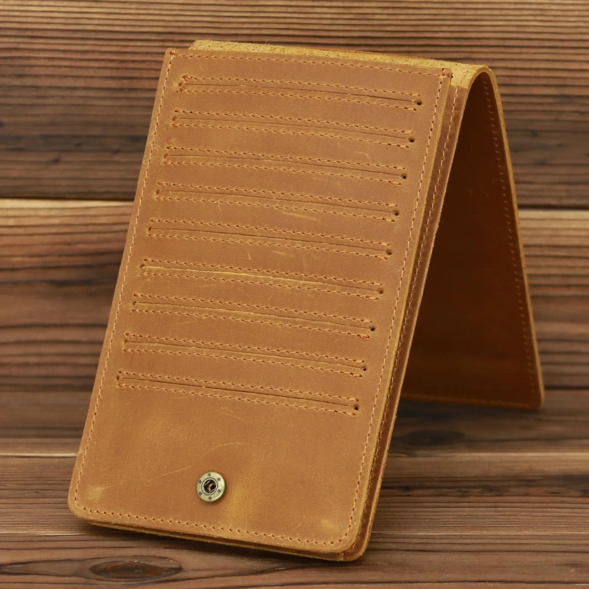 Men's long cowhide leather wallet showing card slots, money pocket, and mobile phone compartment.