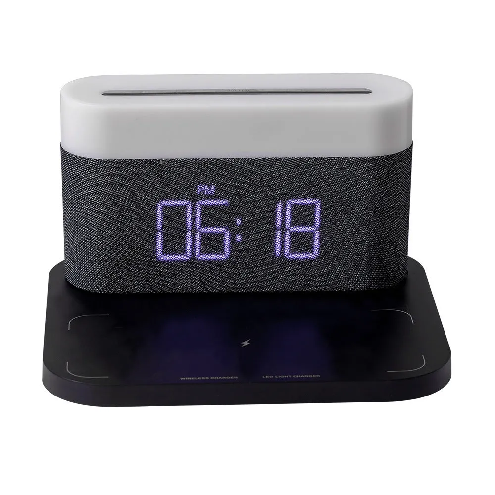Black and white multifunctional table lamp with integrated digital clock and wireless phone charging pad