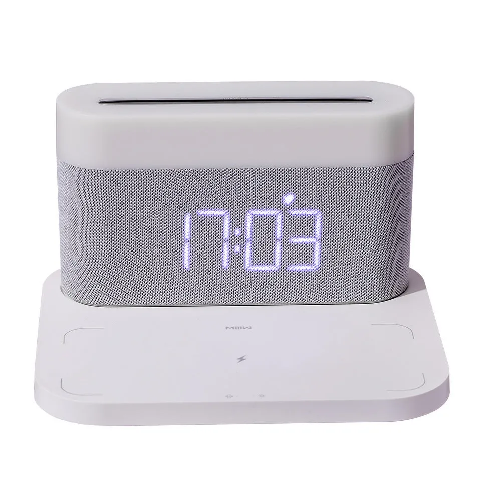 Black and white multifunctional table lamp with integrated digital clock and wireless phone charging pad