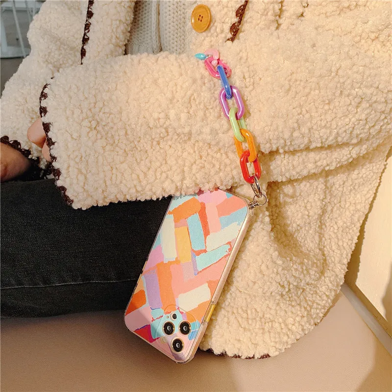 Graffiti design mobile phone case with bracelet strap attached, shown fitting iPhone model