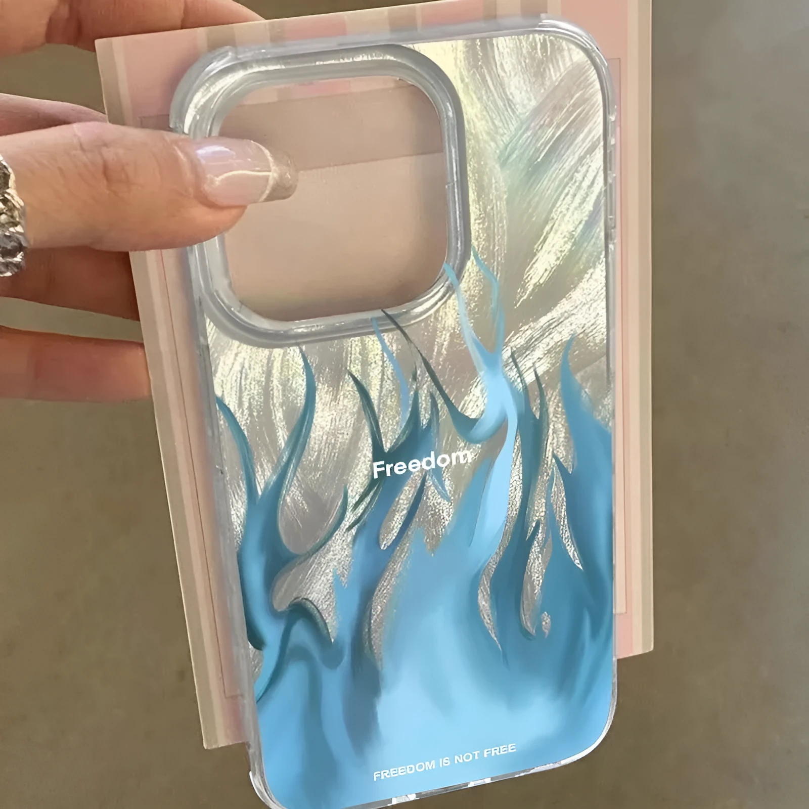 Silicone iPhone case featuring a red and blue floral flame design on a dark background.