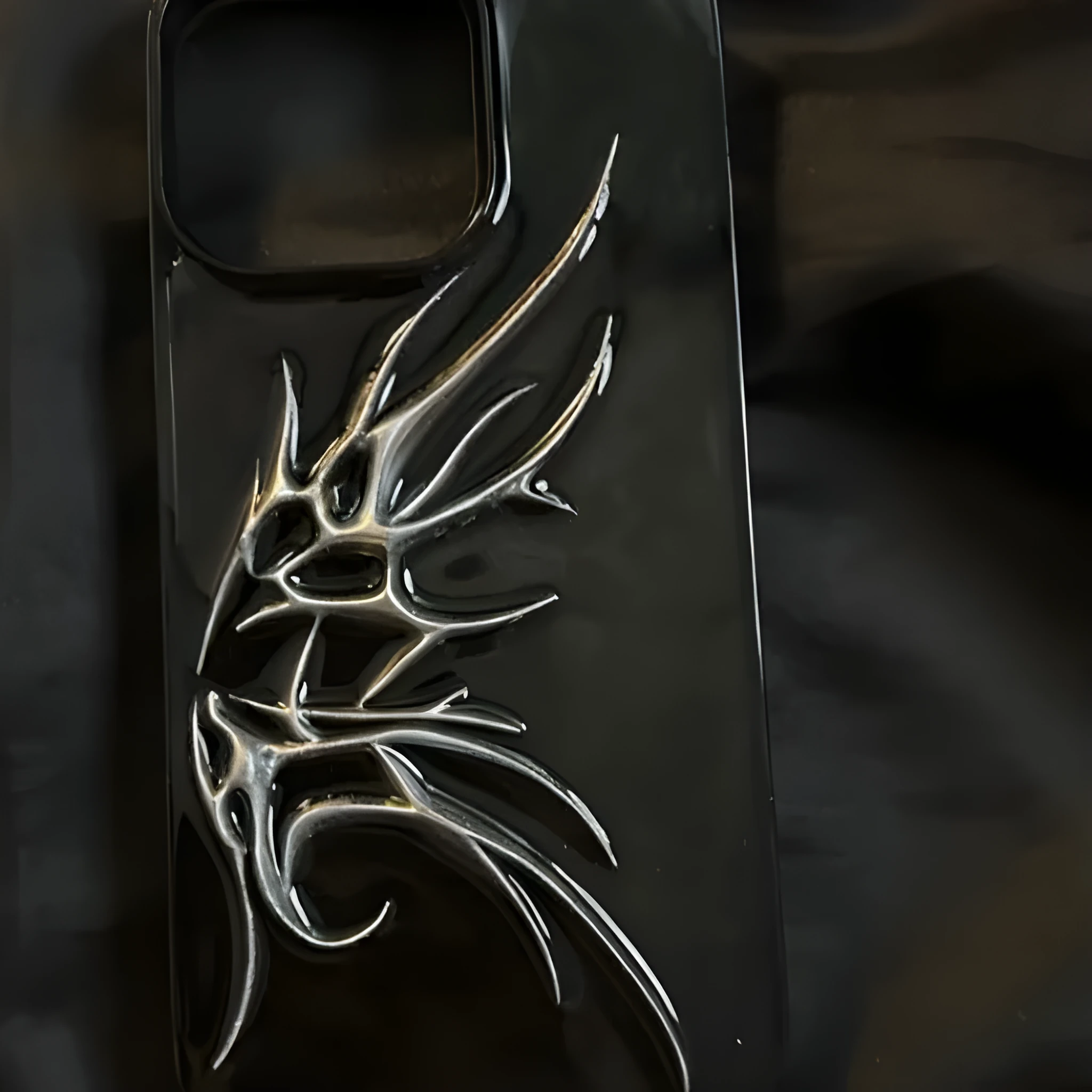 Black iPhone case with three-dimensional blurred wings design showing raised edges and precise port cutouts