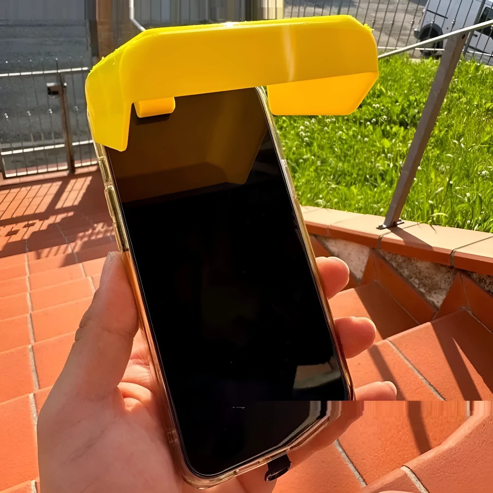 Yellow Creative Beachpool Phone Sunshade Holder clipping onto a smartphone.