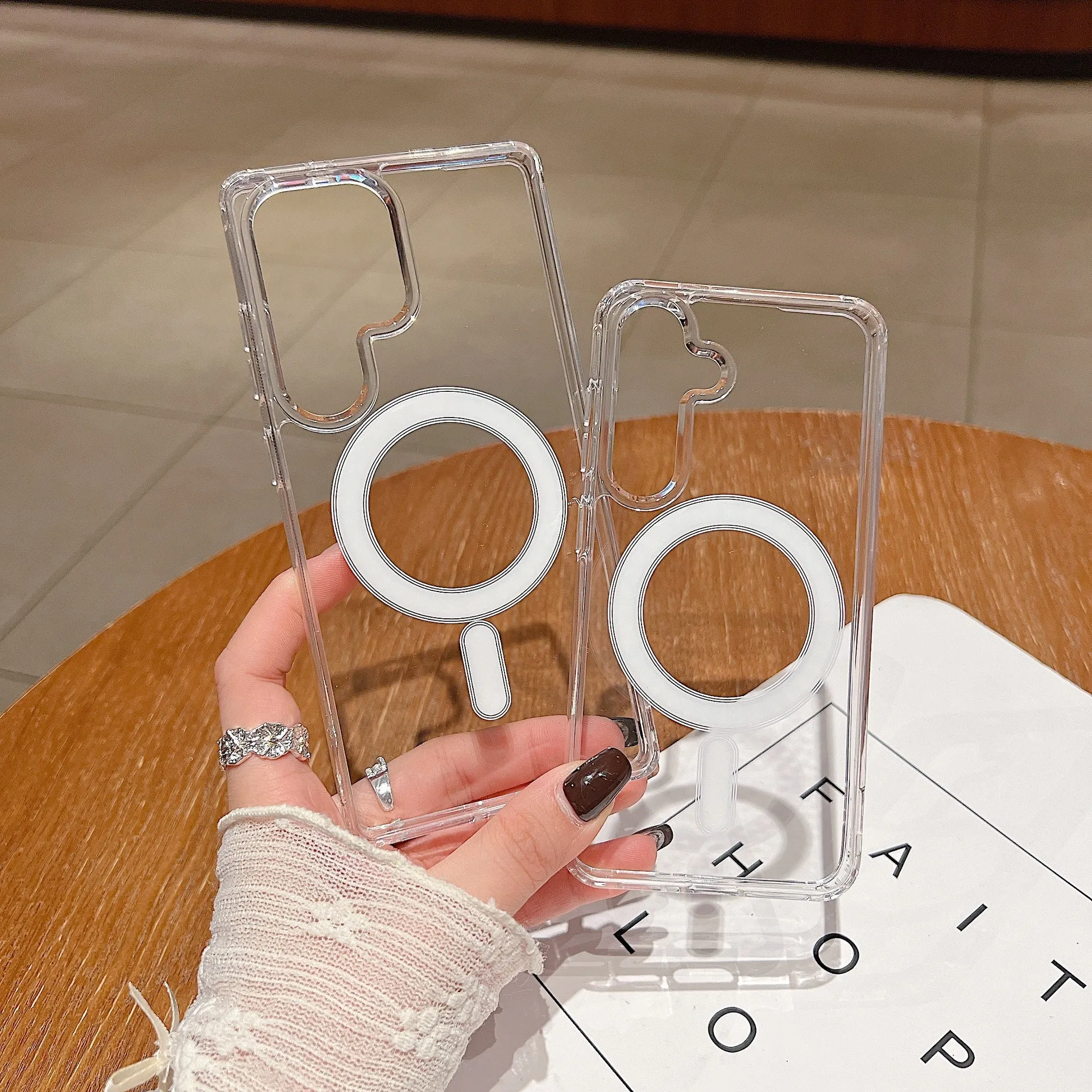 Transparent magnetic silicone phone case for Samsung Galaxy smartphones on a flat surface.
