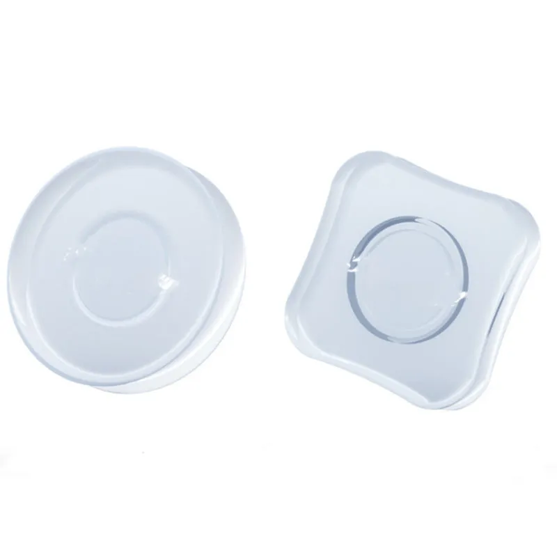 Transparent reusable nano gel adhesive pads in circular and square shapes on a smooth surface