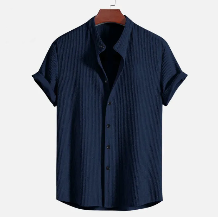 Man wearing a loose-fitting short sleeve summer shirt in a solid colour, showing the relaxed fit and short sleeves.