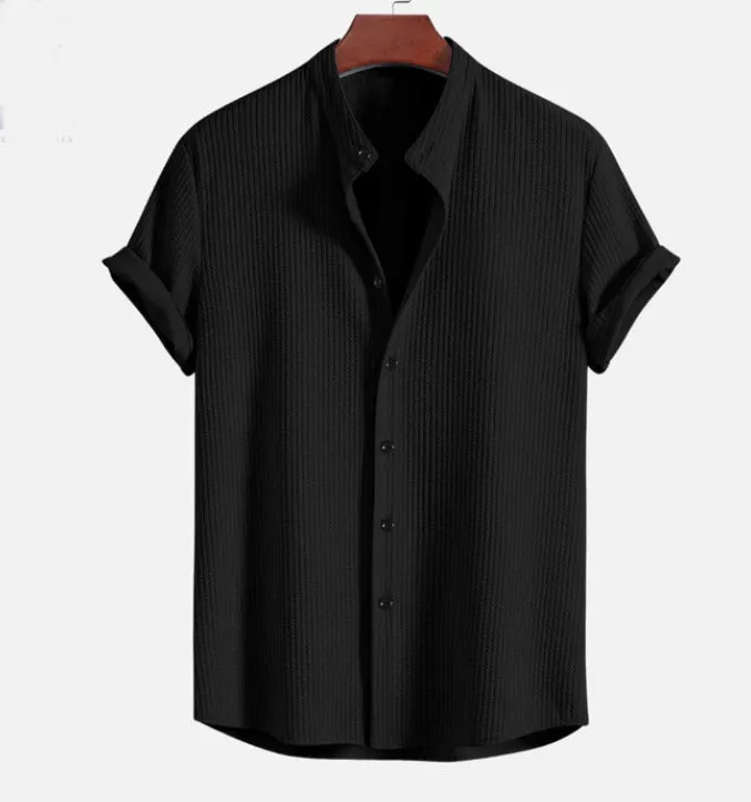 Man wearing a loose-fitting short sleeve summer shirt in a solid colour, showing the relaxed fit and short sleeves.