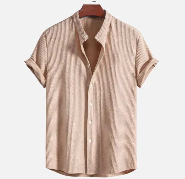 Man wearing a loose-fitting short sleeve summer shirt in a solid colour, showing the relaxed fit and short sleeves.