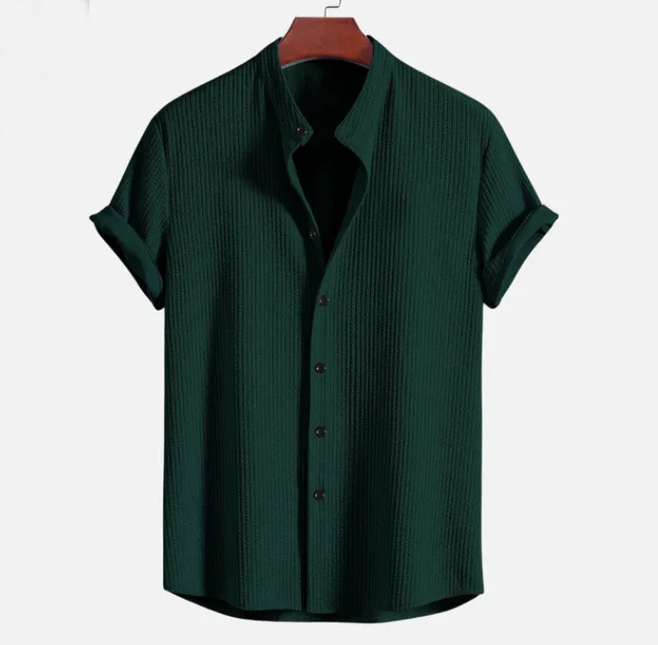 Man wearing a loose-fitting short sleeve summer shirt in a solid colour, showing the relaxed fit and short sleeves.