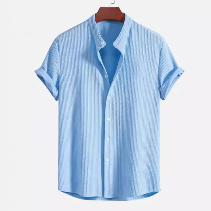 Man wearing a loose-fitting short sleeve summer shirt in a solid colour, showing the relaxed fit and short sleeves.