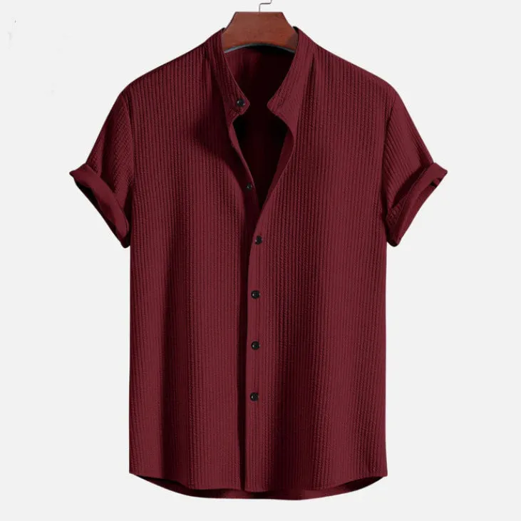 Man wearing a loose-fitting short sleeve summer shirt in a solid colour, showing the relaxed fit and short sleeves.