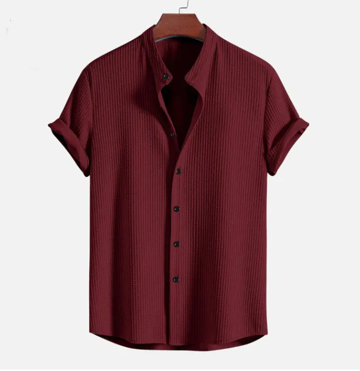 Man wearing a loose-fitting short sleeve summer shirt in a solid colour, showing the relaxed fit and short sleeves.