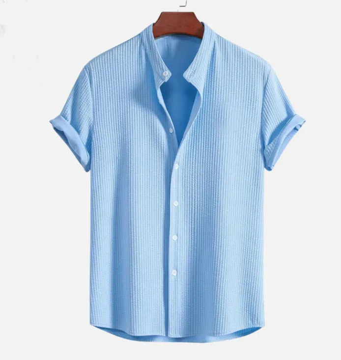Man wearing a loose-fitting short sleeve summer shirt in a solid colour, showing the relaxed fit and short sleeves.