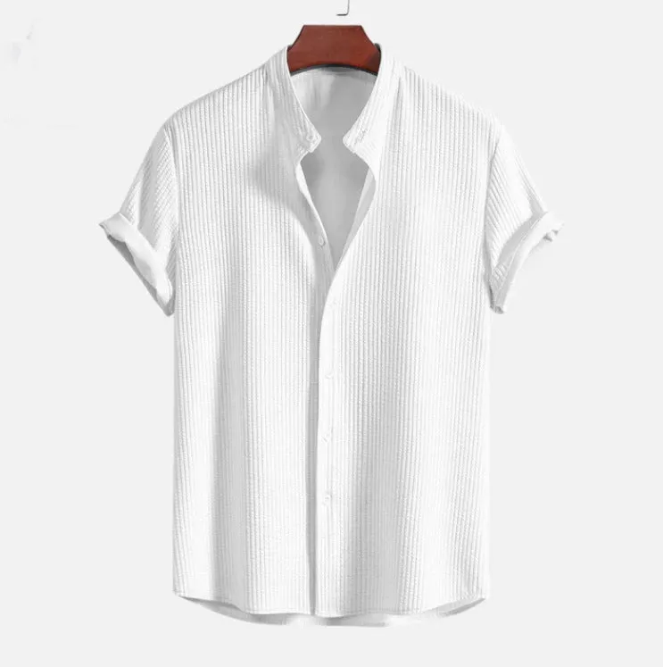 Man wearing a loose-fitting short sleeve summer shirt in a solid colour, showing the relaxed fit and short sleeves.