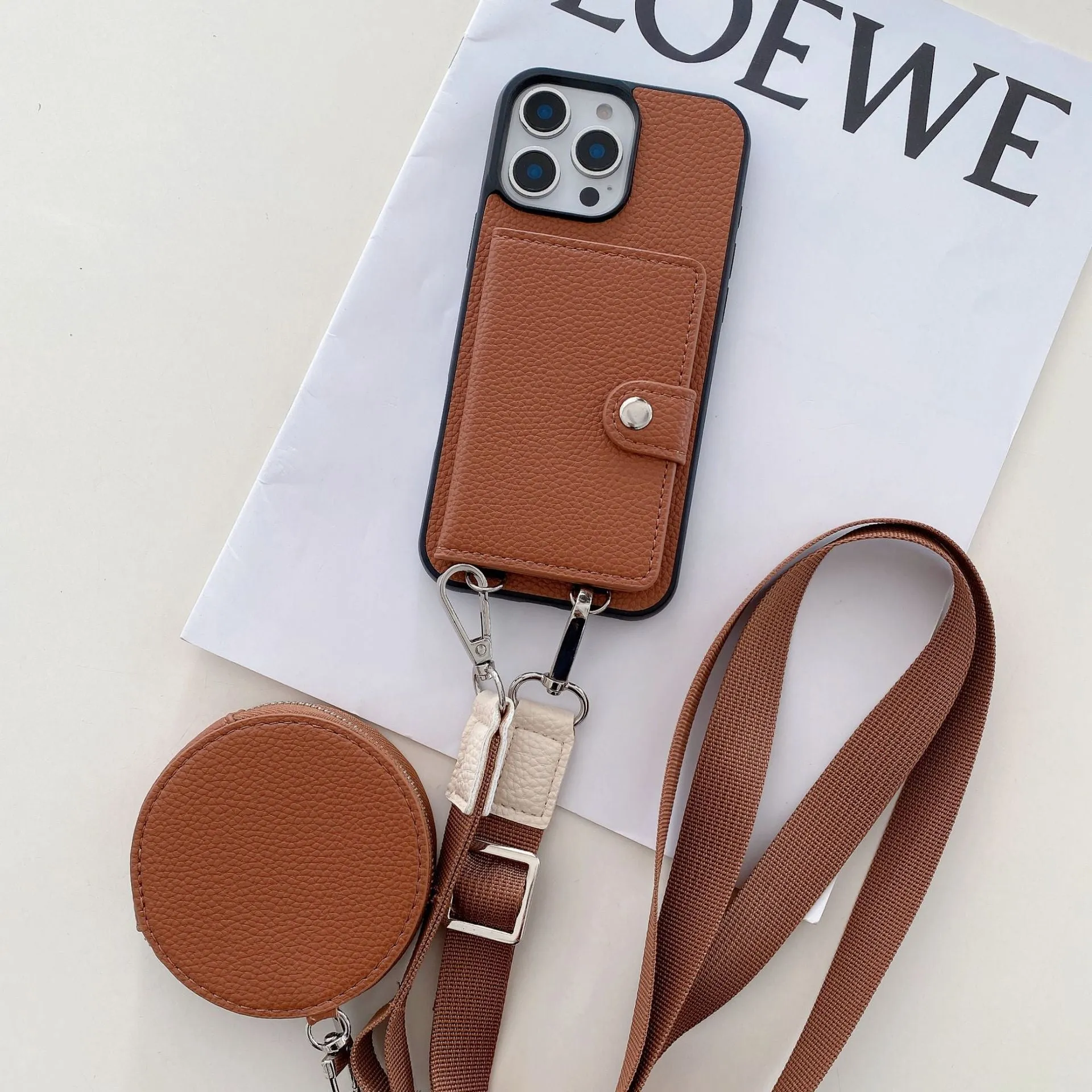 Black PC leather iPhone case with a visible card slot and a lanyard loop on the corner.