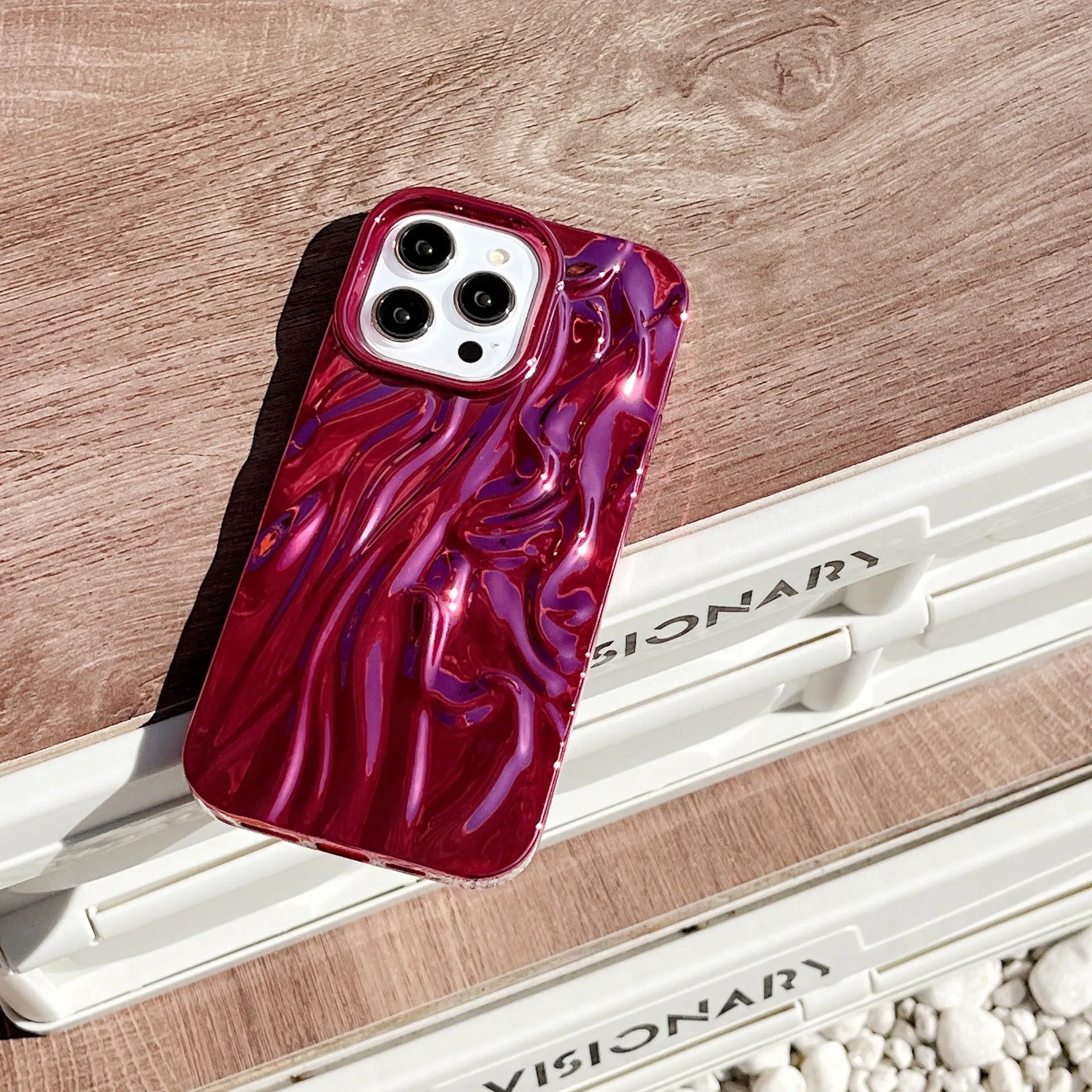 Soft TPU iPhone case with a textured pleated pattern in a rose red electroplated colour.