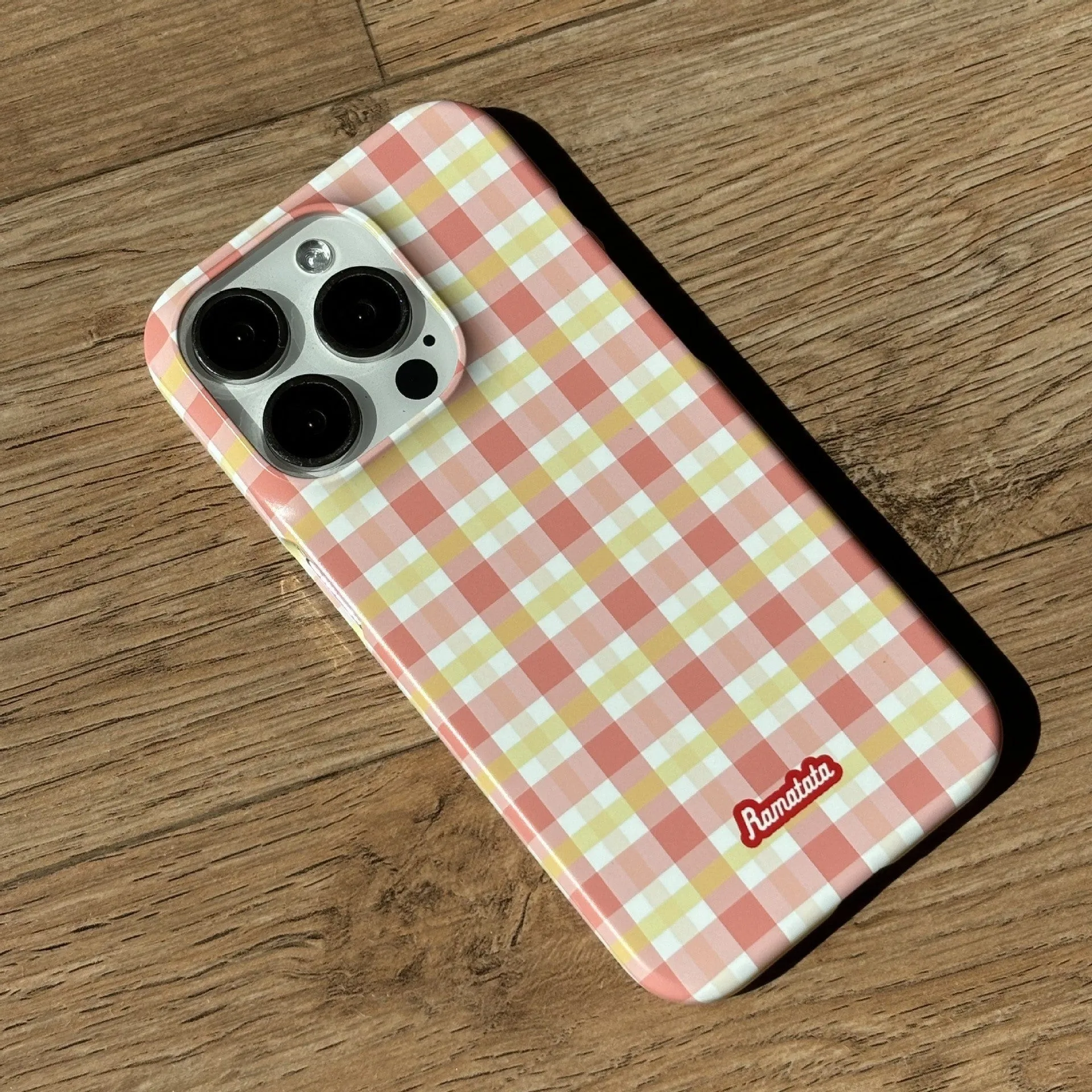 iPhone 15 Pro Max phone case with plaid design in red or orange grid pattern