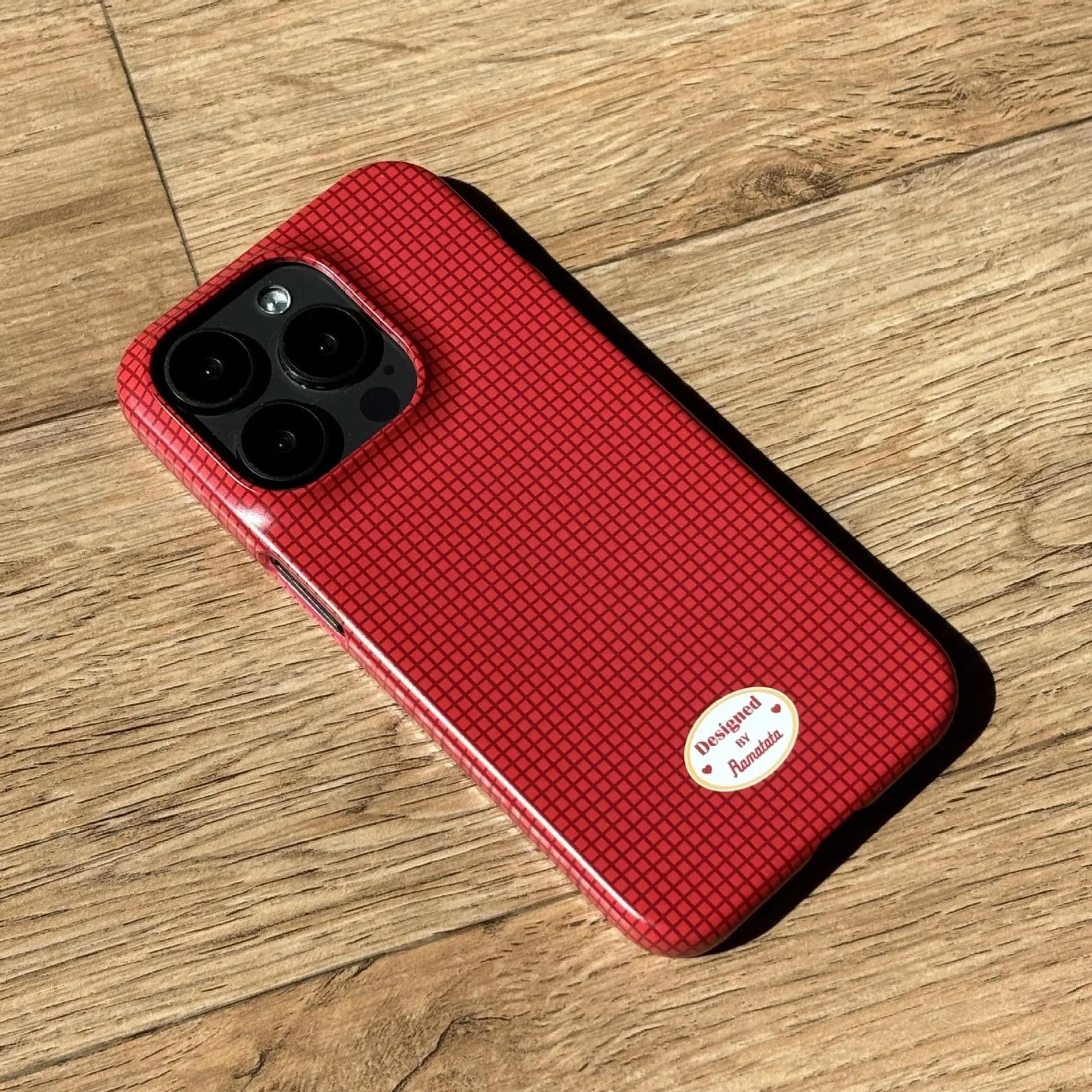iPhone 15 Pro Max phone case with plaid design in red or orange grid pattern