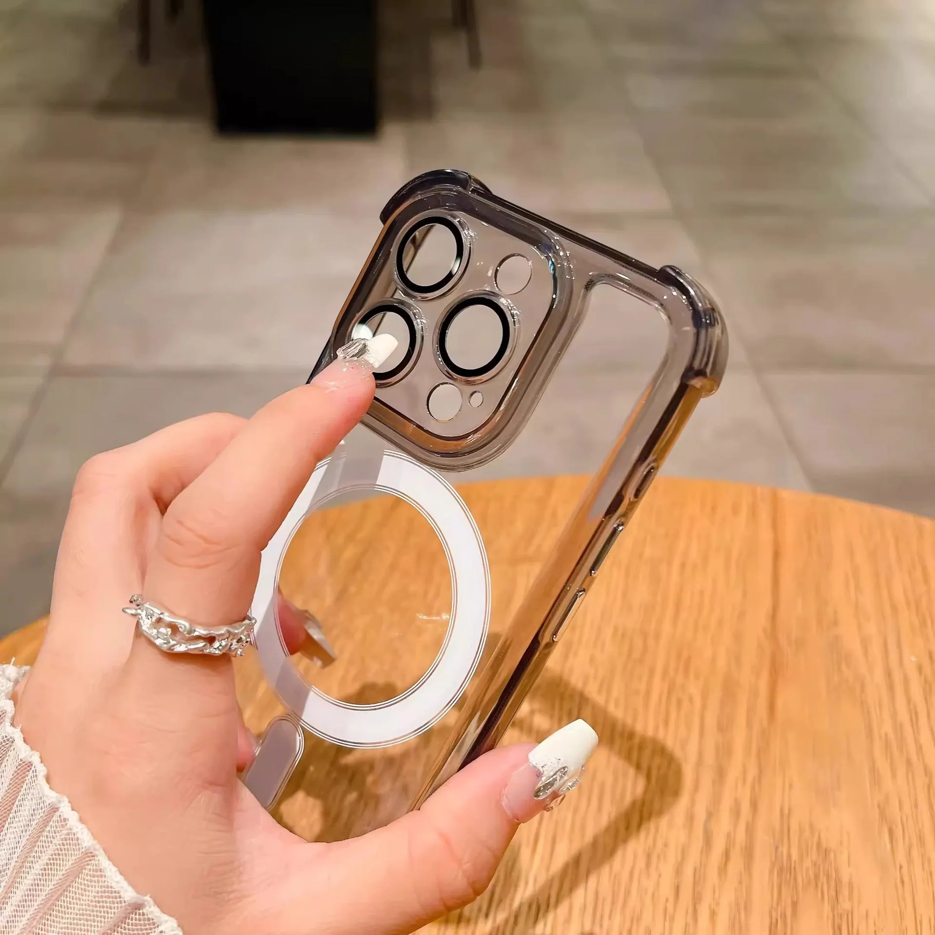 Transparent magnetic airbag silicone phone case with lens protector for iPhone models.