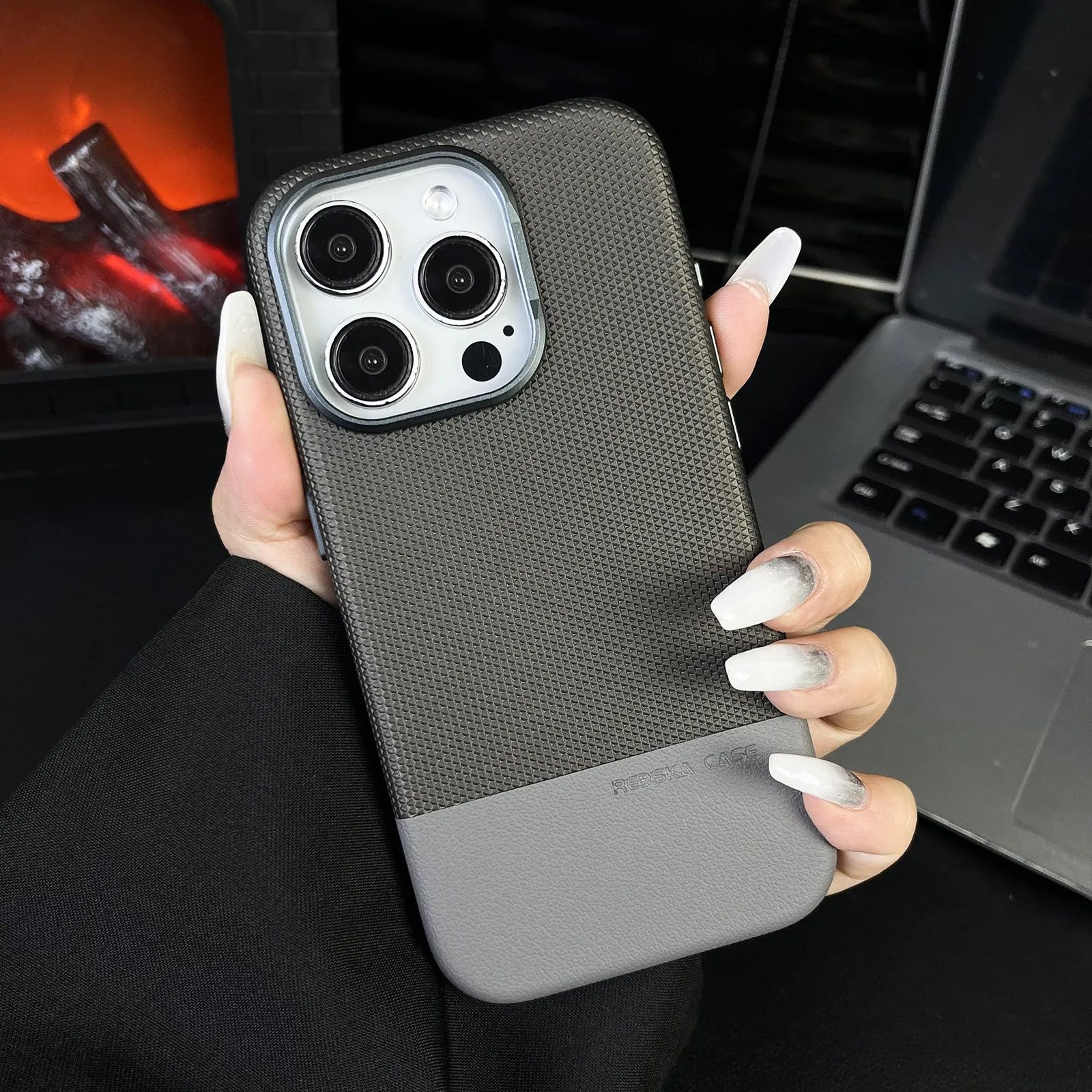 Magnetic iPhone case with dragon scale texture and leather stitching in black colour