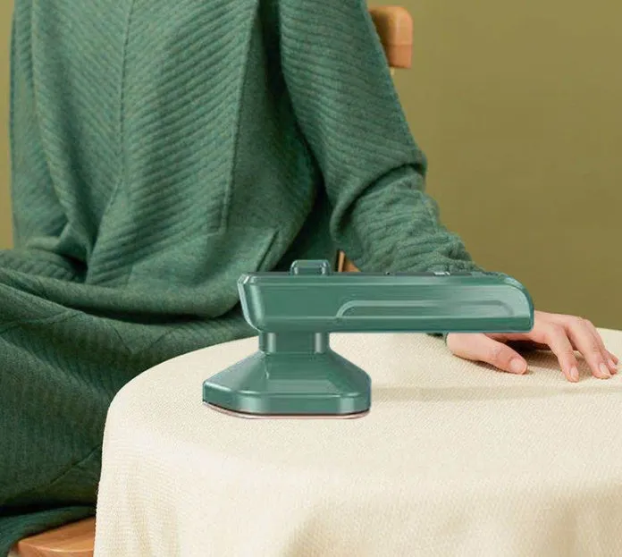 Dark green portable hanging steam ironing machine with ceramic panel.
