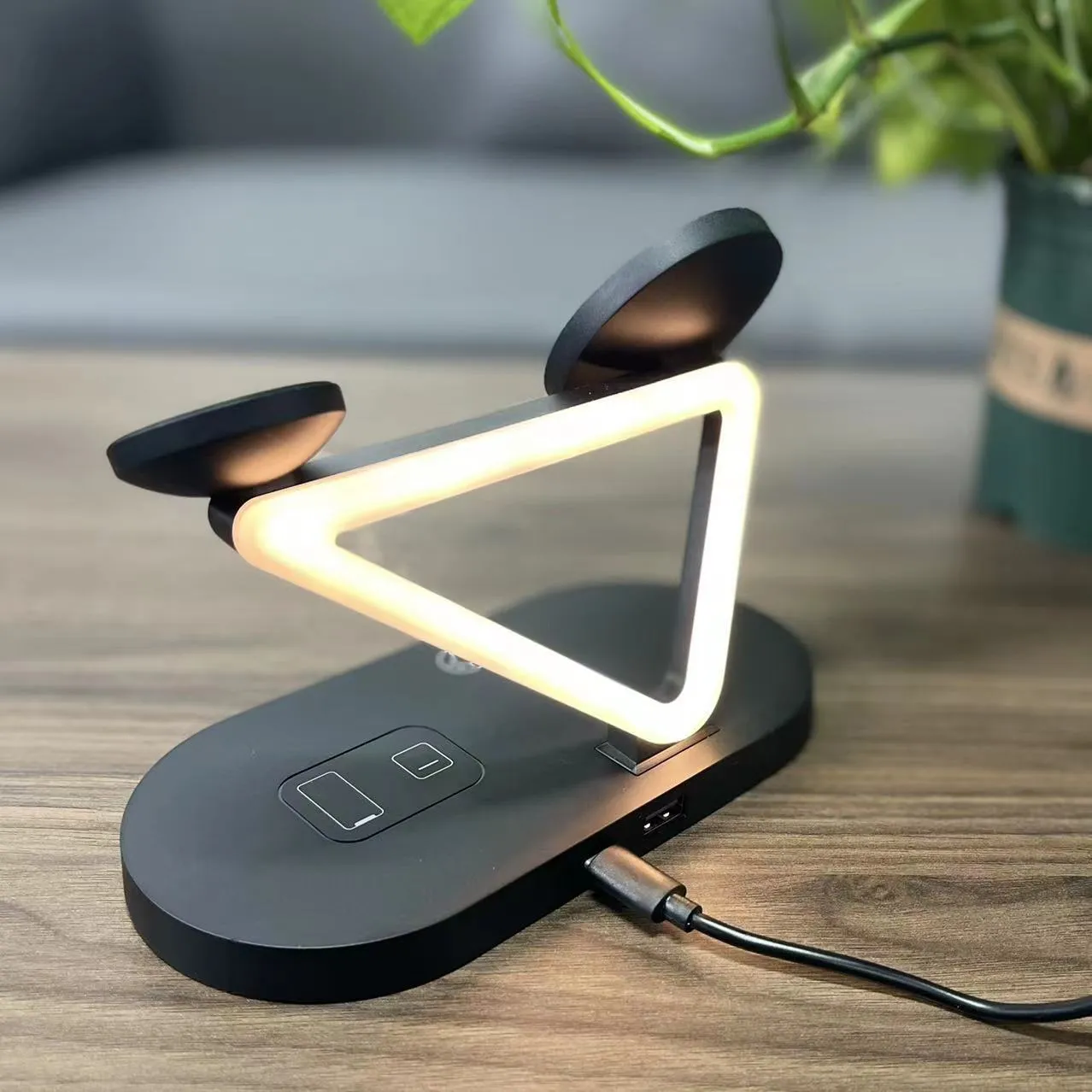 Black wireless charging station showing phone, Apple Watch and AirPods case charging simultaneously