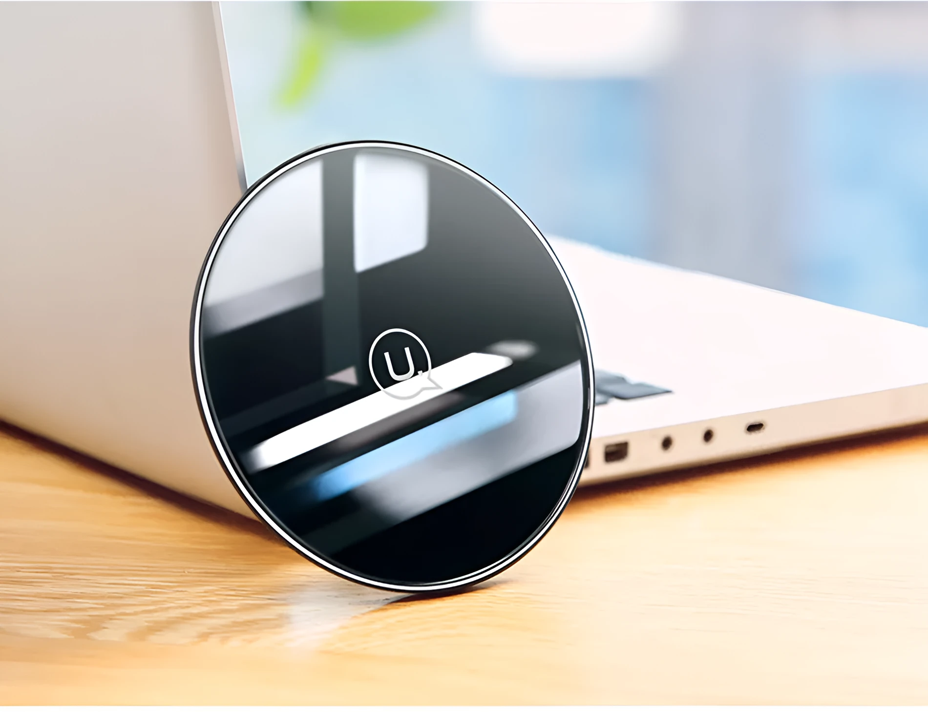 Black or white glass disc wireless charger on a surface, showing status light.