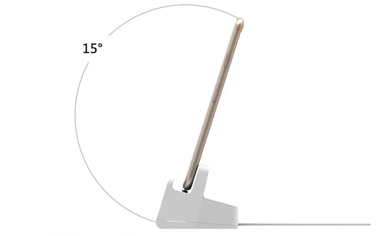 White headphone charging base station on a desk, holding a pair of over-ear headphones.