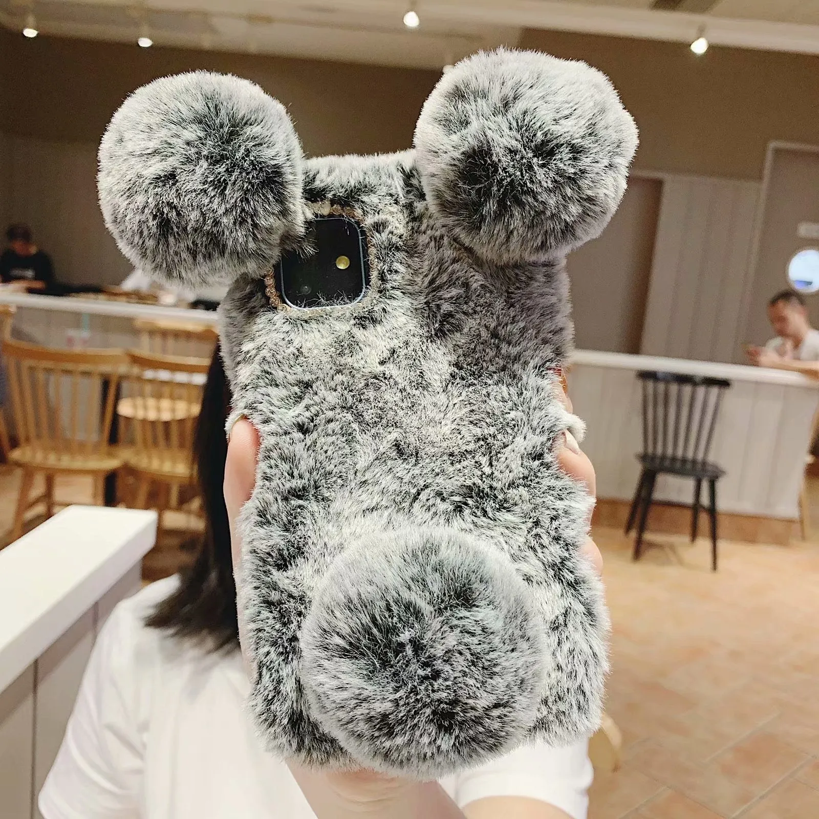 Soft grey bear plush TPU back cover case on an iPhone 11.