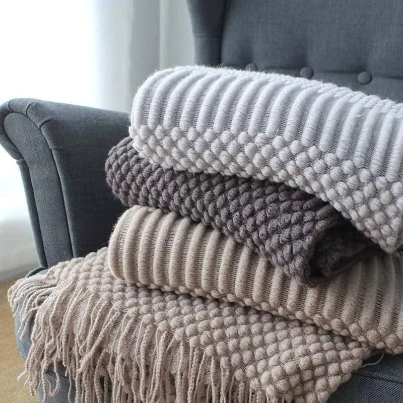 Small grey polyester nap blanket folded, showing its size and texture.