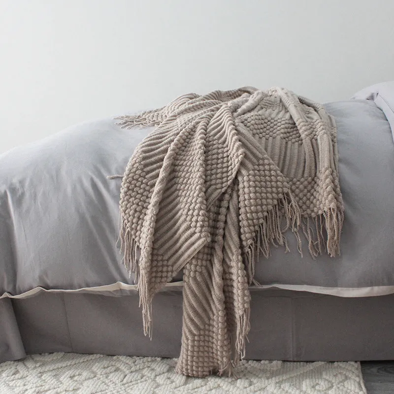 Small grey polyester nap blanket folded, showing its size and texture.