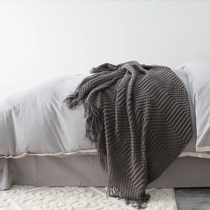Small grey polyester nap blanket folded, showing its size and texture.