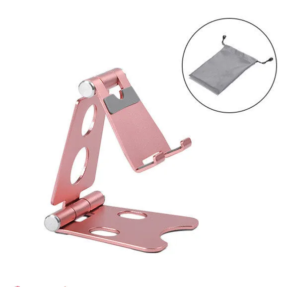 Foldable metal mini phone stand in gold black colour on a wooden desk