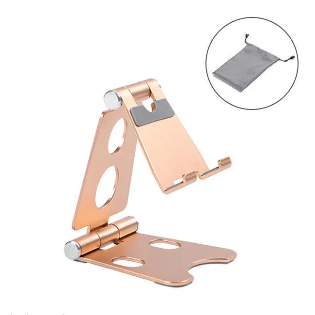 Foldable metal mini phone stand in gold black colour on a wooden desk